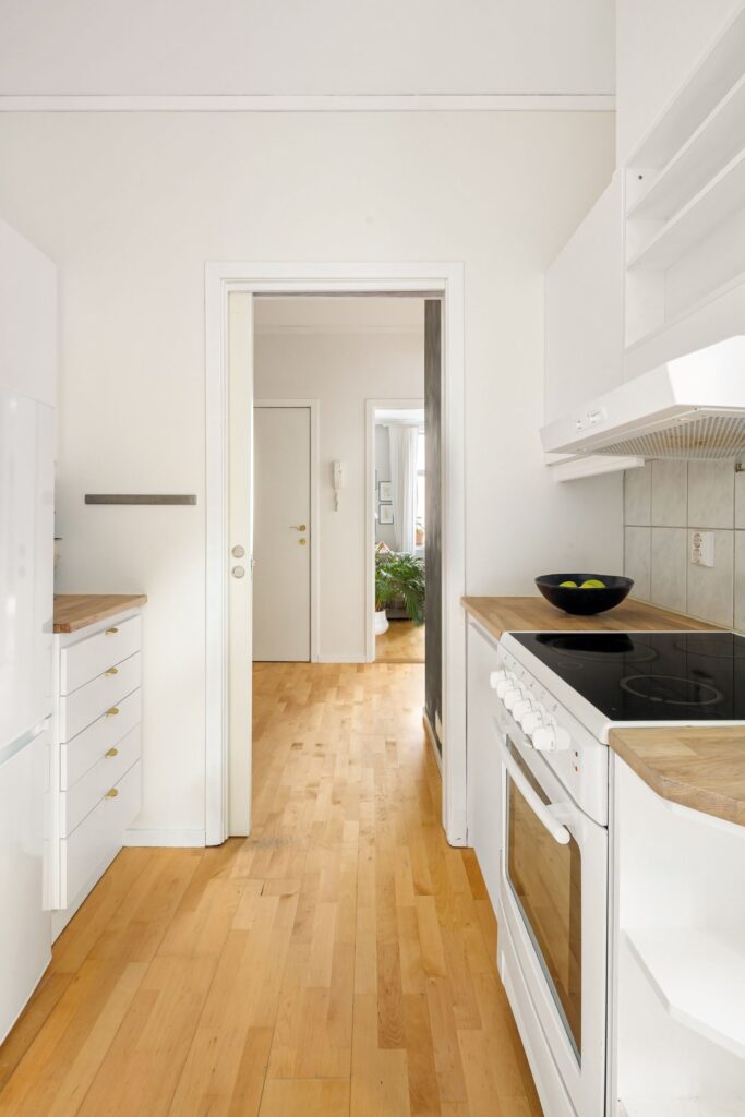 Bright compact kitchen with clean cabinetry and flooring